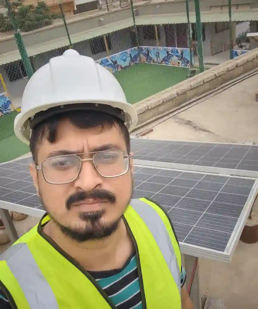 Engr. Syed Farrukh Anwar inspecting MPPT solar controller at NGO school