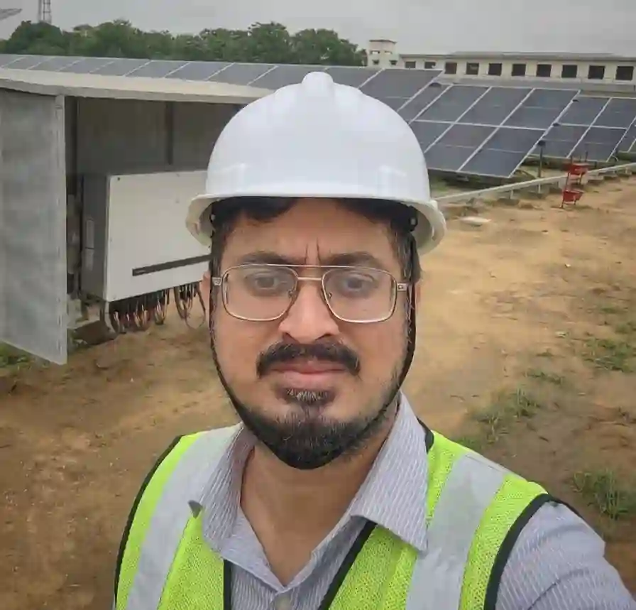 Commercial solar maintenance — solar renewable engineer conducting on-site inspection at a ground-mounted solar farm with inverter cabinet